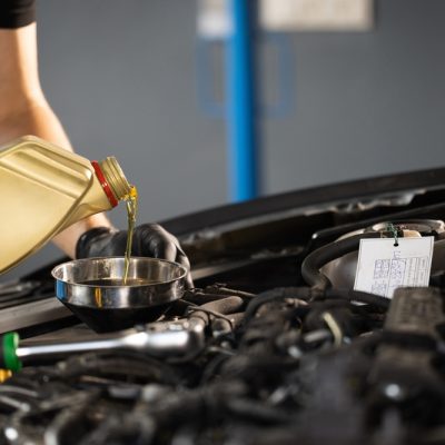Close,Up,Of,Pouring,Fresh,New,Motor,Oil,Into,Car's
